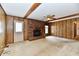A living room with brick fireplace, door to outside, and wood paneling features at 3451 N County Road 100 E, Danville, IN 46122