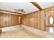 A living room features wood paneling, a ceiling fan, and doorway leading to the front door at 3451 N County Road 100 E, Danville, IN 46122