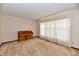 Inviting living room with soft carpeting, a classic wooden piano, and a large window with sheer curtains at 3451 N County Road 100 E, Danville, IN 46122