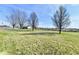 Exterior view of a rustic outbuilding set amidst a sprawling, grassy landscape at 3451 N County Road 100 E, Danville, IN 46122