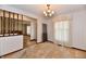 The carpeted room is complete with a chandelier and transitions to an adjacent area with patterned flooring at 3451 N County Road 100 E, Danville, IN 46122