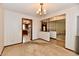 A carpeted room has a chandelier and looks into adjacent rooms, inviting openness at 3451 N County Road 100 E, Danville, IN 46122