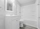 A full white bathroom featuring a shower, vanity, mirror, toilet, and new fixtures at 3710 Orchard Ave, Indianapolis, IN 46218