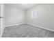 Bright bedroom with neutral carpet, freshly painted, and a window letting in natural light at 3710 Orchard Ave, Indianapolis, IN 46218