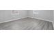 Simple bedroom design with gray flooring, light-colored walls, and natural light from two windows at 3710 Orchard Ave, Indianapolis, IN 46218