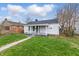 A quaint one-story house with a cozy front porch and a simple, inviting facade at 3710 Orchard Ave, Indianapolis, IN 46218