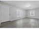Inviting living room featuring neutral paint, gray flooring, and ample natural light through multiple windows at 3710 Orchard Ave, Indianapolis, IN 46218