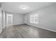 Open-concept living area with modern gray floors, fresh paint, and a view into adjacent rooms at 3710 Orchard Ave, Indianapolis, IN 46218