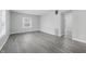 Bright, spacious living room with fresh paint, modern gray flooring, and abundant natural light at 3710 Orchard Ave, Indianapolis, IN 46218