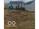 Backyard featuring grass, a deck, and a detached garage at 3907 Haverhill Dr, Anderson, IN 46013