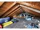 Unfinished attic space with exposed rafters and wood flooring, providing potential for future expansion or storage at 3940 N Drexel Ave, Indianapolis, IN 46226