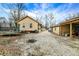 Backyard view showcasing a gravel area, trampoline, and single-story house connected to a detached garage at 3940 N Drexel Ave, Indianapolis, IN 46226