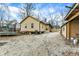A backyard featuring gravel, trampoline, and fence is connected to the single-story home and a detached garage at 3940 N Drexel Ave, Indianapolis, IN 46226