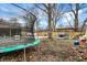 Backyard features a trampoline, scattered leaves, and various other features like a hammock and swing at 3940 N Drexel Ave, Indianapolis, IN 46226