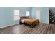 Bedroom with hardwood floors and light blue walls features natural light and closet at 3940 N Drexel Ave, Indianapolis, IN 46226
