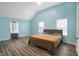 Spacious bedroom features light blue walls and hardwood flooring at 3940 N Drexel Ave, Indianapolis, IN 46226
