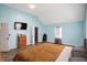 Spacious bedroom with TV features light blue walls and hardwood floors at 3940 N Drexel Ave, Indianapolis, IN 46226