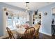 Cozy dining room with wooden chairs, table with floral centerpiece, and decorative window at 3940 N Drexel Ave, Indianapolis, IN 46226