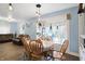 Open concept dining room flows into living area with cozy furniture and bright natural light at 3940 N Drexel Ave, Indianapolis, IN 46226