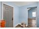 Hallway features light blue walls, hardwood flooring, and access to other rooms at 3940 N Drexel Ave, Indianapolis, IN 46226