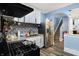 Well-equipped kitchen features stainless steel refrigerator and dark backsplash tiles at 3940 N Drexel Ave, Indianapolis, IN 46226
