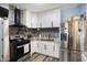 Modern kitchen showcasing stainless steel fridge, granite counters, and decorative backsplash at 3940 N Drexel Ave, Indianapolis, IN 46226