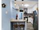 Bright kitchen features granite countertops, white cabinets, stainless steel appliances, and a breakfast bar at 3940 N Drexel Ave, Indianapolis, IN 46226