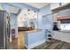 Open kitchen leading to living area features hardwood floors, light blue walls, and modern lighting at 3940 N Drexel Ave, Indianapolis, IN 46226