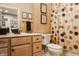 Well-lit bathroom featuring wooden vanity with framed mirror, modern toilet, and shower with neutral colored curtain at 4030 Statesmen Dr, Indianapolis, IN 46250