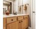 Bathroom vanity with light wood cabinets, white countertops, and stylish faucet and fixtures at 4030 Statesmen Dr, Indianapolis, IN 46250