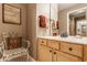 Bathroom featuring a vanity with wood cabinets, a modern faucet, and a decorative chair at 4030 Statesmen Dr, Indianapolis, IN 46250