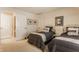 Bright bedroom featuring two beds with decorative pillows and neutral carpet at 4030 Statesmen Dr, Indianapolis, IN 46250