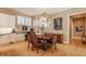 Cozy dining area with ample natural light, stylish chandelier, and stairway at 4030 Statesmen Dr, Indianapolis, IN 46250