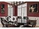 This dining room features hardwood floors, bold paint and decorative trim at 4030 Statesmen Dr, Indianapolis, IN 46250