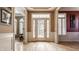 Bright foyer with gleaming hardwood floors and a welcoming entryway through a paneled door at 4030 Statesmen Dr, Indianapolis, IN 46250