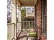 Cozy front porch with seating offers a relaxing outdoor space with brick flooring and classic railings at 4030 Statesmen Dr, Indianapolis, IN 46250