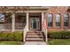 Inviting front porch with classic brick steps, white pillars, and an American flag adds charm at 4030 Statesmen Dr, Indianapolis, IN 46250