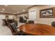 Open floorplan showing a game table and a nearby entertainment area with leather sofas, TV, and home decor at 4030 Statesmen Dr, Indianapolis, IN 46250
