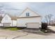 White two-car garage with carriage doors in a suburban neighborhood at 4030 Statesmen Dr, Indianapolis, IN 46250