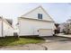 Attached two-car garage with carriage doors and well-maintained landscaping at 4030 Statesmen Dr, Indianapolis, IN 46250