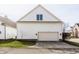 Two-car garage features carriage doors, brick accents, and manicured lawn at 4030 Statesmen Dr, Indianapolis, IN 46250