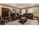 Inviting finished basement featuring dual leather sofas, decorative pillows, and accent tables for stylish comfort at 4030 Statesmen Dr, Indianapolis, IN 46250