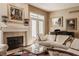 Elegant living room with fireplace, piano, and stylish decor creates a sophisticated ambiance at 4030 Statesmen Dr, Indianapolis, IN 46250
