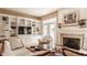 Comfortable living room with a fireplace and built-in shelves offers a perfect blend of style and functionality at 4030 Statesmen Dr, Indianapolis, IN 46250
