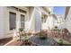 Charming brick patio with wrought iron furniture and vibrant floral arrangements, perfect for outdoor relaxation at 4030 Statesmen Dr, Indianapolis, IN 46250