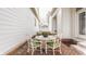 Enclosed brick patio with comfortable seating and floral arrangements, ideal for outdoor entertaining and relaxation at 4030 Statesmen Dr, Indianapolis, IN 46250