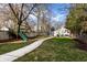 Wide backyard with a play set, swing set, and a garage, offering plenty of room for Gathering activities and storage at 4350 N College Ave, Indianapolis, IN 46205