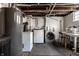 Basement laundry room featuring modern washer and dryer units and ample space for chores and storage at 4350 N College Ave, Indianapolis, IN 46205