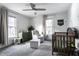 Serene Bedroom with gray walls, plush carpeting, modern ceiling fan, and a classic wooden crib for a calming, comfortable space at 4350 N College Ave, Indianapolis, IN 46205