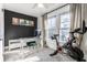 Bright bedroom featuring a Peloton bike, desk, and a cozy chair for an active and productive space at 4350 N College Ave, Indianapolis, IN 46205